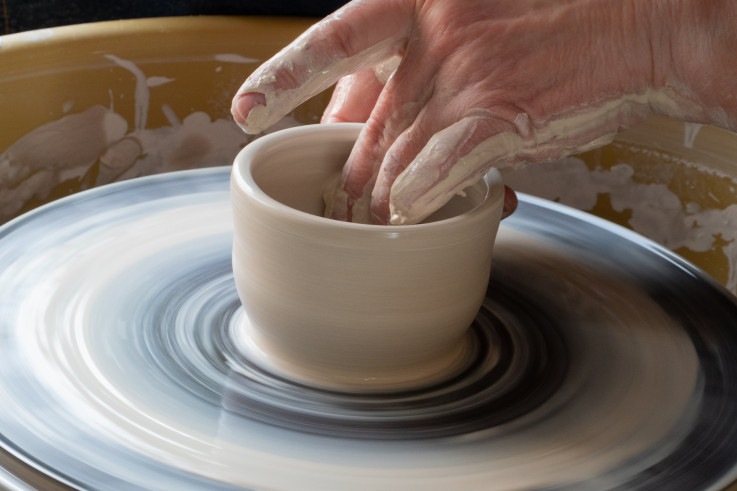Creating cups on a potter's wheel