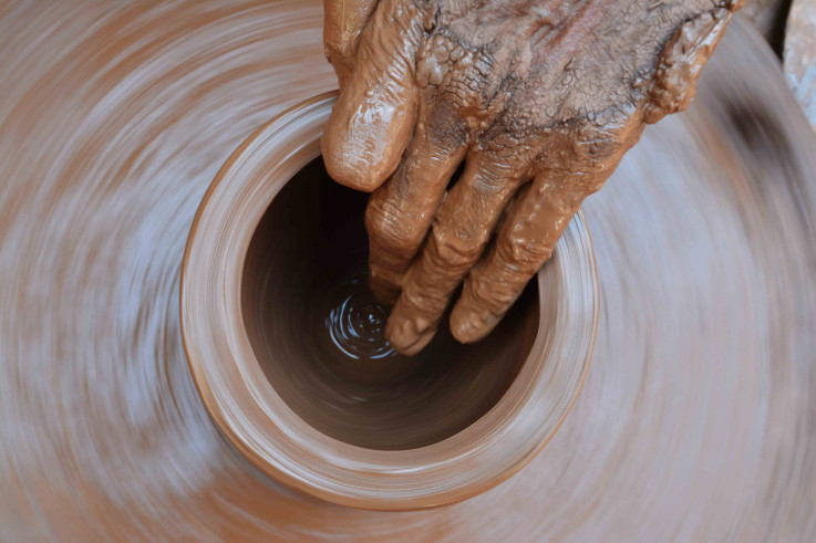 Throwing a clay pot on a potter's wheel