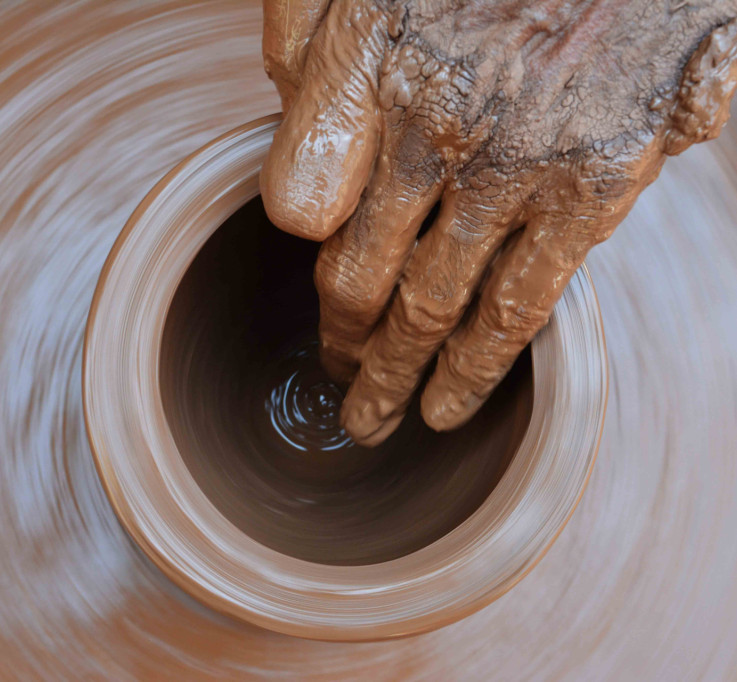 Throwing a clay pot on a potter's wheel